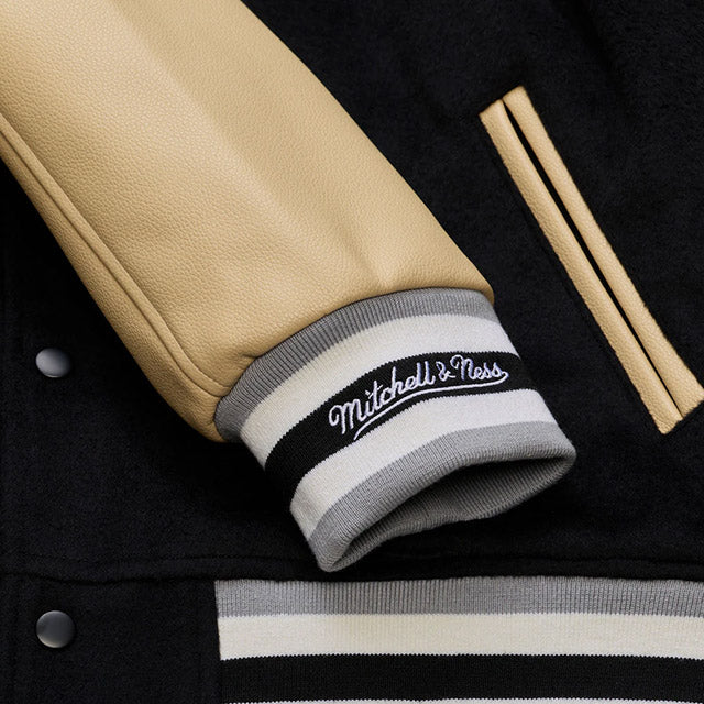 海外取寄 ミッチェル&ネス スタジアムジャケット ラスベガス レイダース NFL TEAM TRADITIONS VARSITY FULL-SNAP JACKET BLACK-TAN