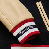 海外取寄 ミッチェル&ネス スタジアムジャケット サンフランシスコ 49ERS NFL TEAM TRADITIONS VARSITY FULL-SNAP JACKET BLACK-TAN